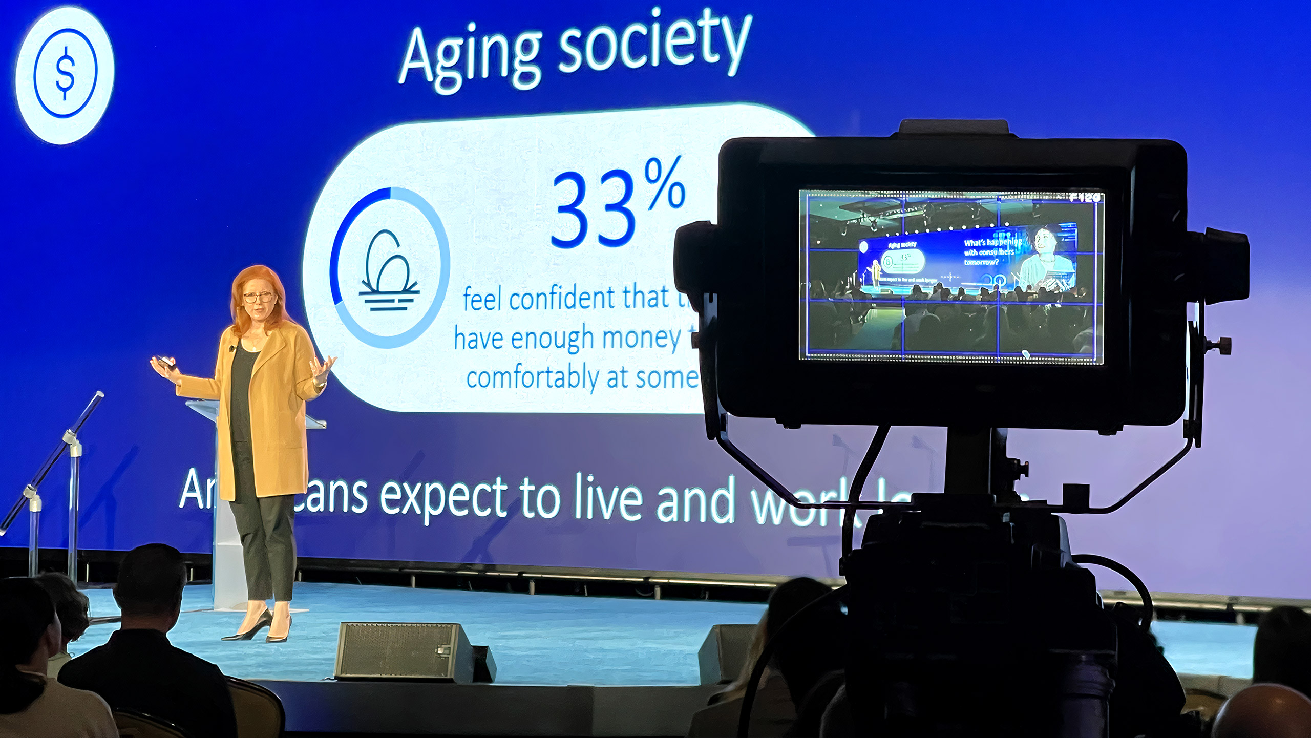 Camera recording presenter on stage